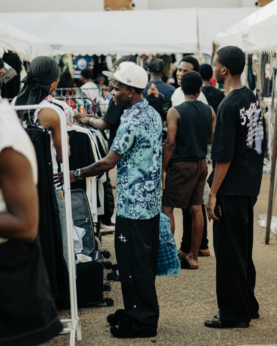 A vendor arranging upcycled pieces at their booth