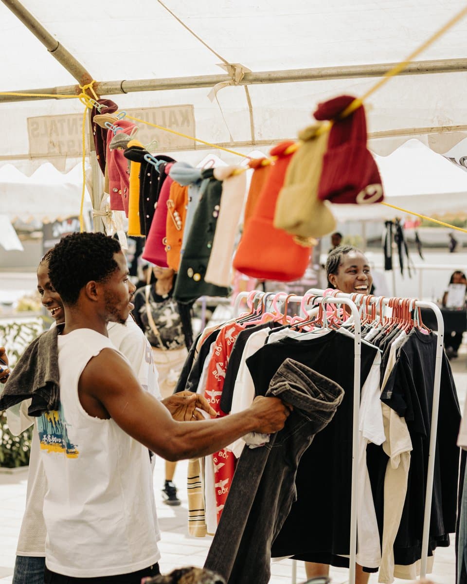 A stallholder folding upcycled denim at the market